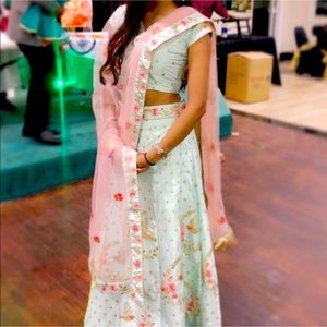 Pastel teal and peach lengha set with beautiful gold and embroidery with birds.